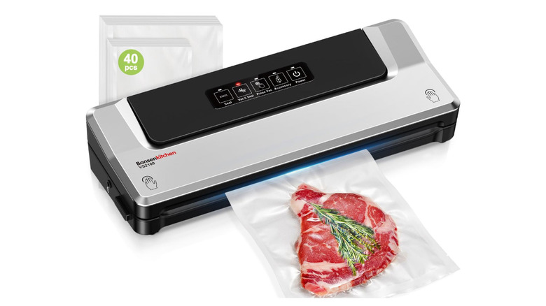 food sealer with steak and herbs in a bag