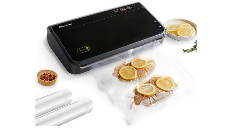 black vacuum sealer with chicken and lemons