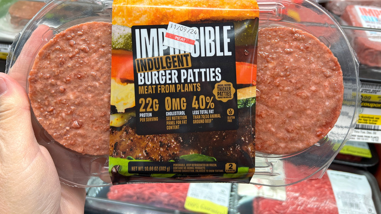 hand holding Impossible burger patties