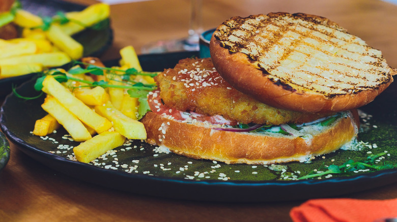 lentil burger on bun with fries