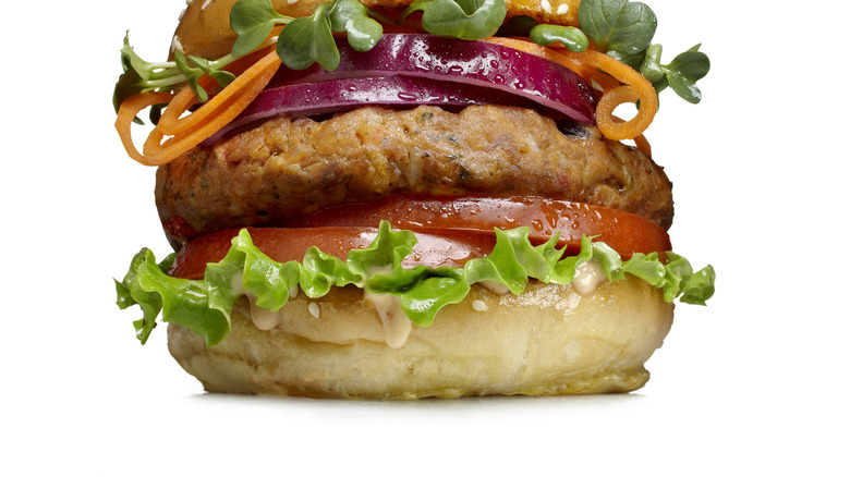 vegetable burger with onion, tomatoes, and carrots