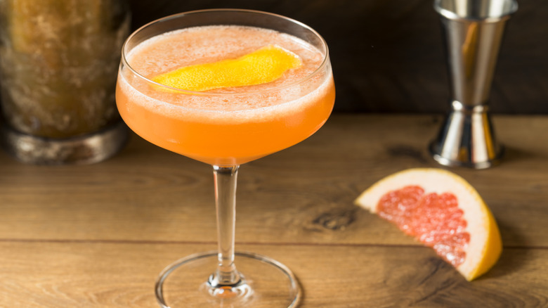 A Brown Derby cocktail with a grapefruit in the background