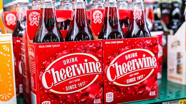 Two four packs of Cheerwine on a grocery store shelf