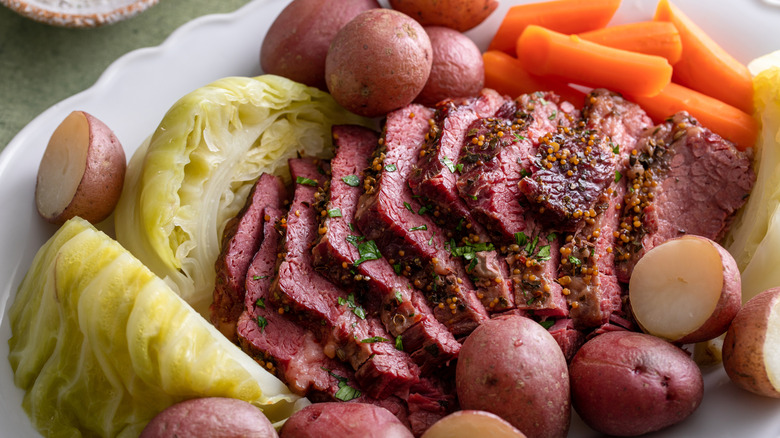 Sliced corned beef with cabbage, potatoes, and carrots