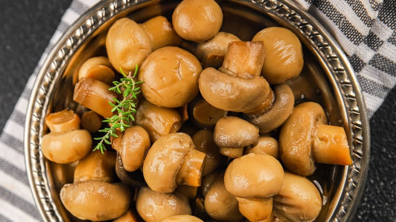 Canned whole mushrooms in a bowl.