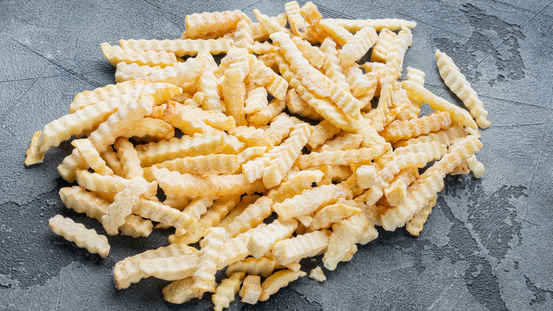 Frozen fries on a gray background.