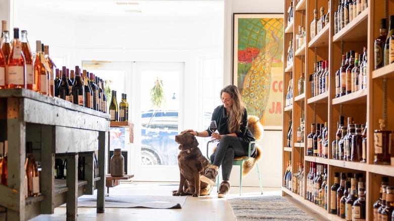 Lauren Hokin pets dog at Town Cellar