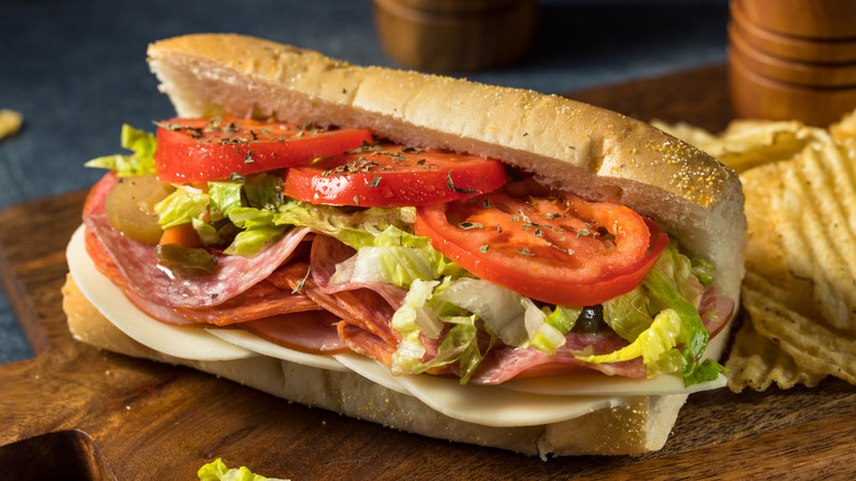 An Italian sub on a cutting board.