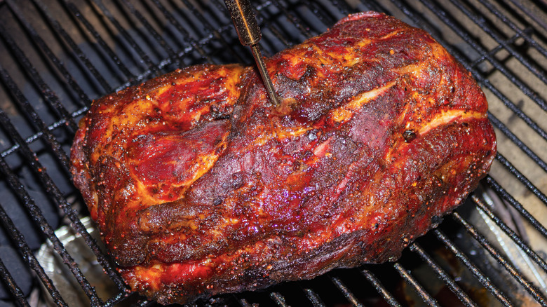 A pork roast on a barbecue grill.