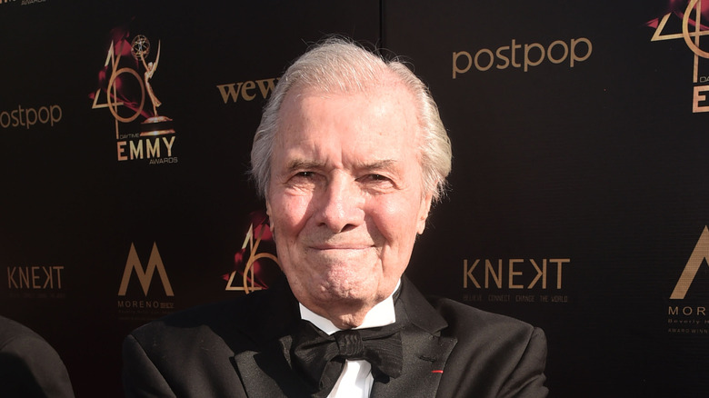 Jacques Pépin standing against an Emmy's backdrop
