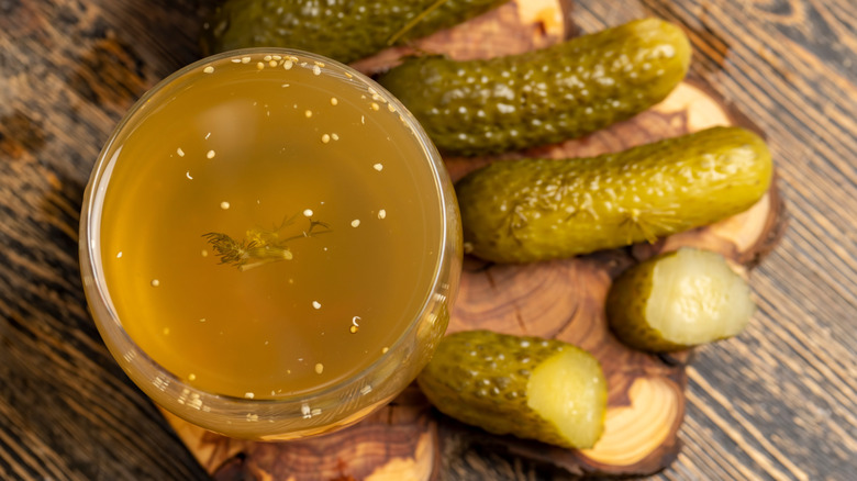 pickles and pickle juice in a glass