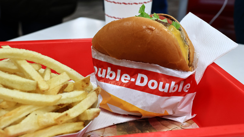 Double-Double from In-N-Out served with a side of fries on a red tray