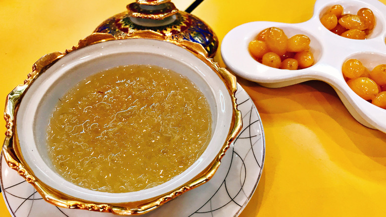 A bowl of prepared bird's nest soup on a yellow background