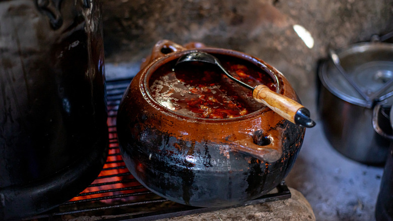 A pot of birria  cooking on a burner