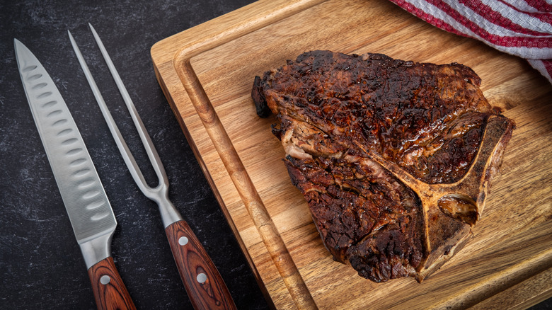A porterhouse steak resting on a cutting board