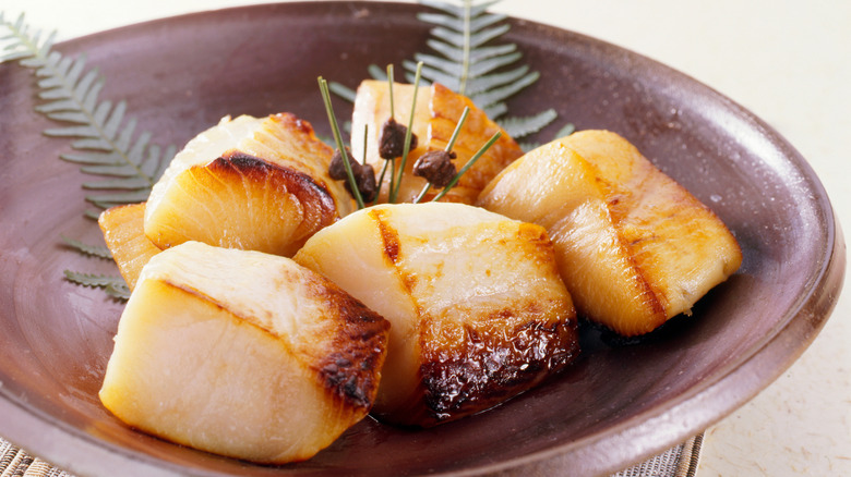 Broiled black cod with miso in a ceramic bowl.