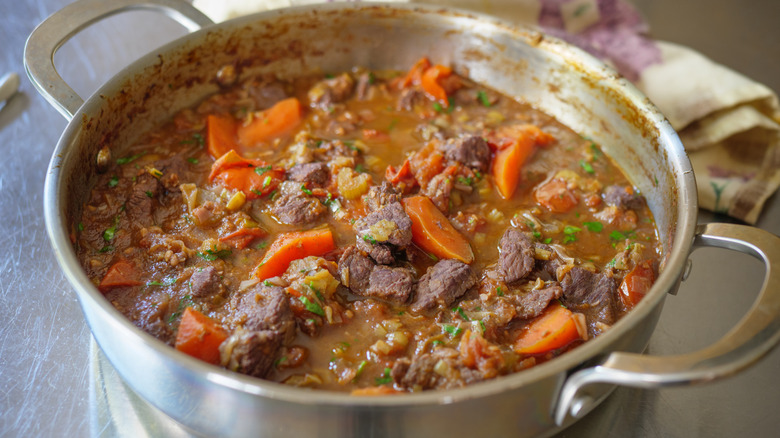 A large metal pot of beef stew.