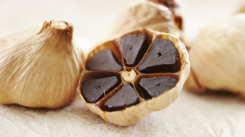 Black garlic sliced through the middle to display black cloves
