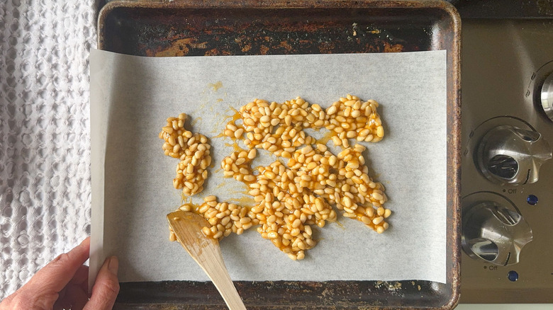 Candied pine nuts on parchment-lined baking sheet