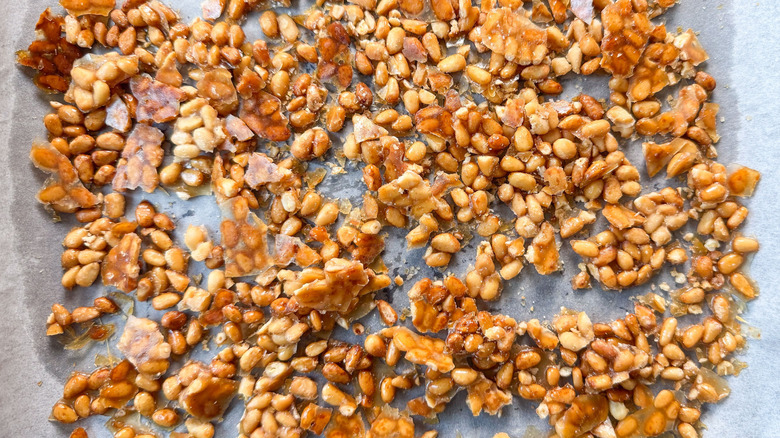 Candied pine nuts on parchment-lined baking sheet
