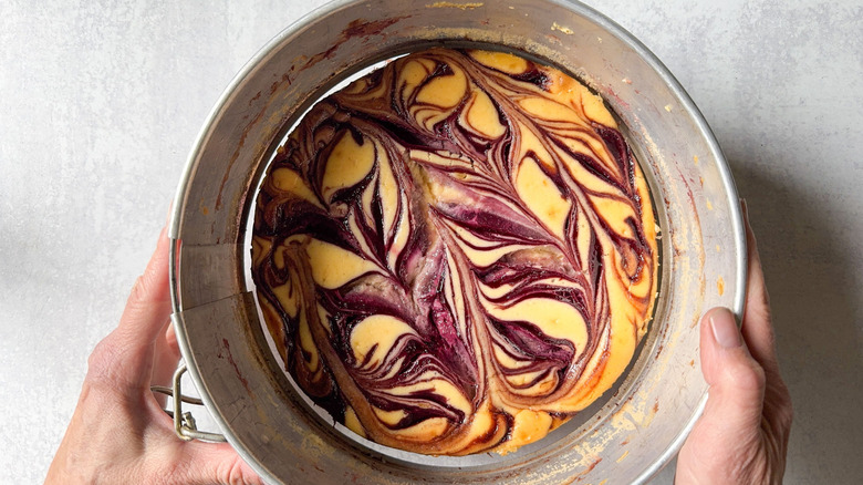 Releasing blackberry marbled cheesecake from springform pan