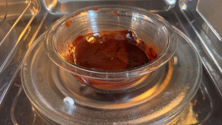 Melted chocolate in glass bowl in microwave