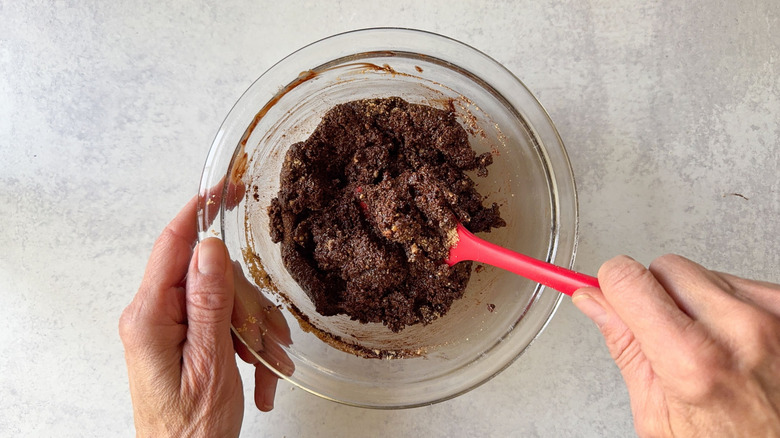 Melted chocolate and graham cracker crumbs in glass bowl