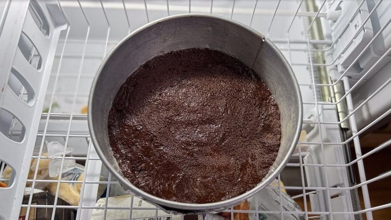 Chocolate graham cracker crust in springform pan in freezer