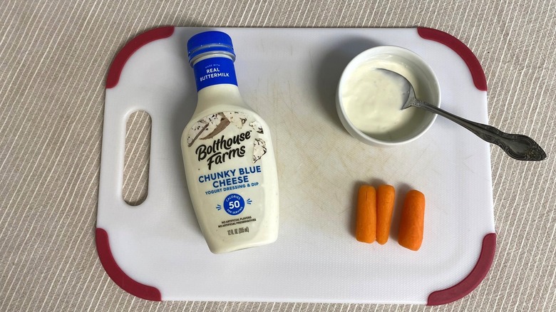 Bolthouse Farms blue cheese dressing on a table with sample and baby carrots