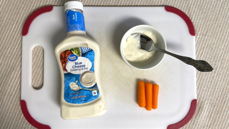 Great Value Blue Cheese dressing on a table with sample and baby carrots