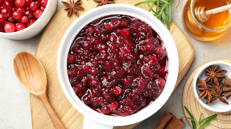 A white bowl full of cranberry sauce.