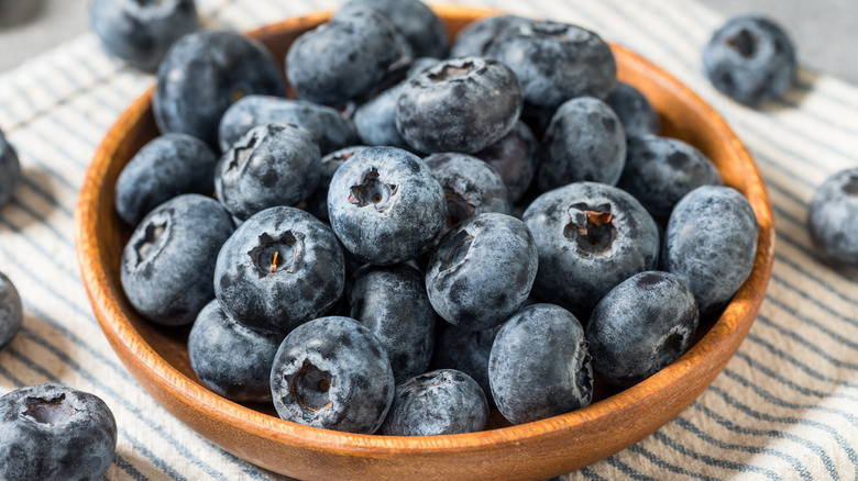 Organic Raw Big Giant Jumbo Blueberries in a Wooden Bowl
