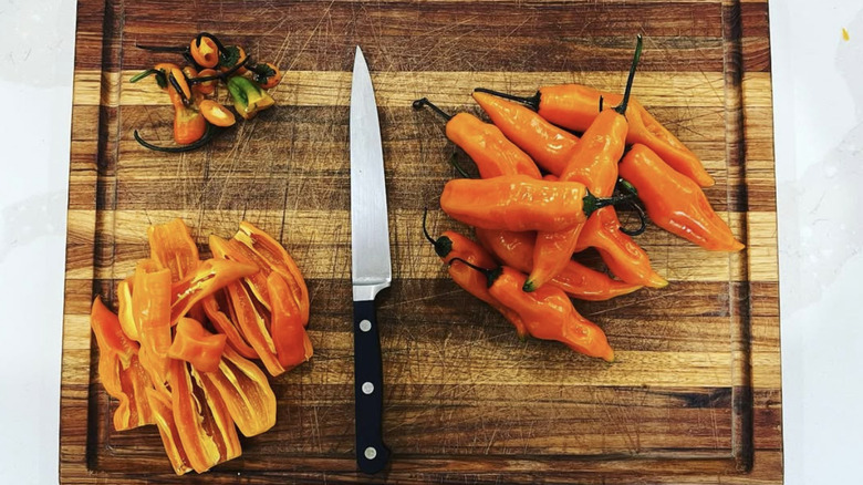 Aji amarillo peppers on wood