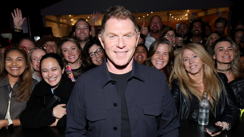 Bobby Flay standing with fans