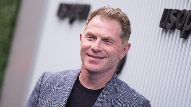 Celebrity chef Bobby Flay at a red carpet event.