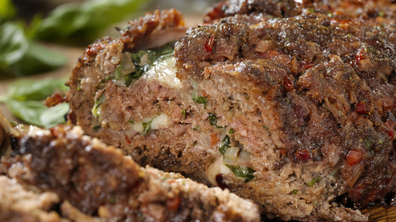Sliced meatloaf is photographed in close-up to picture its interior.