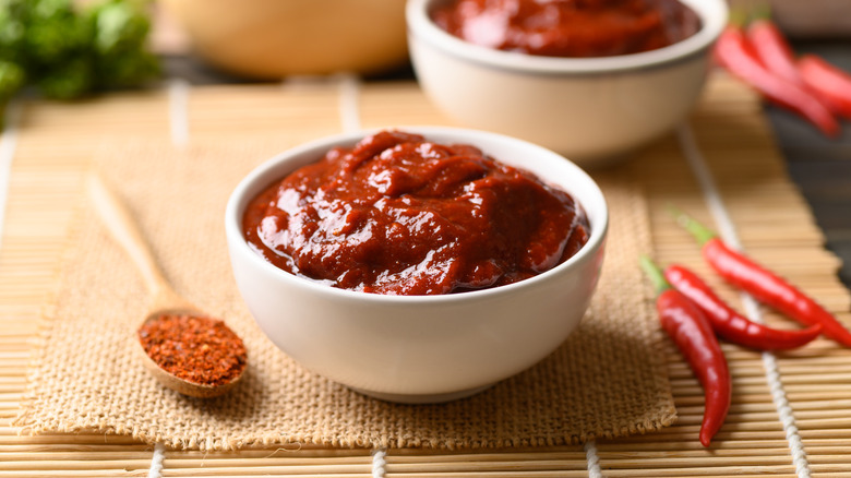 A white bowl full of red gochujang.