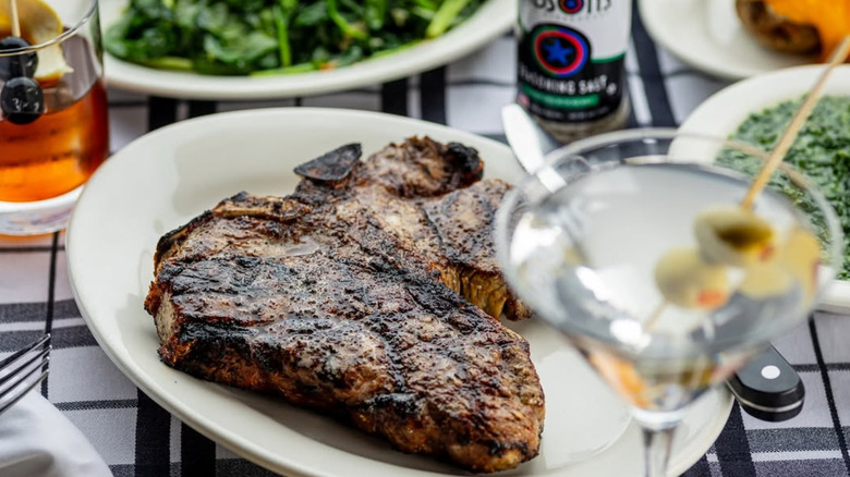 T-bone steak, cocktails, and sides at Gibsons