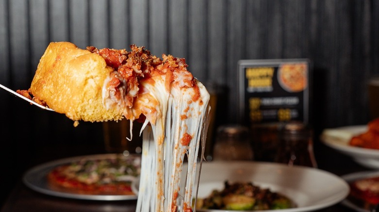 a very cheesy pizza slice pull