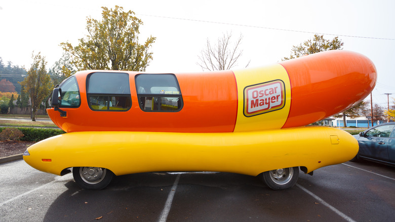The Oscar Mayer Weinermobile in a parking lot.