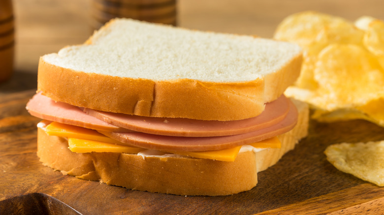 A bologna sandwich with chips.