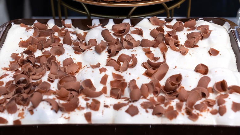 Large pudding casserole with whipped cream and chocolate shavings