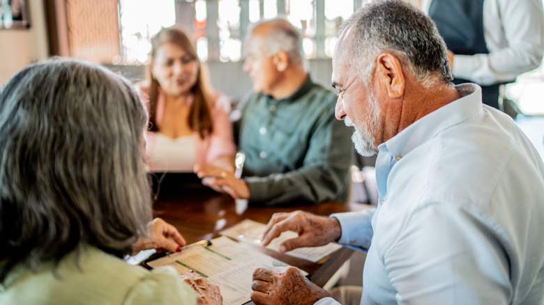 A senior couple reading a menu before ordering at a restaurant
