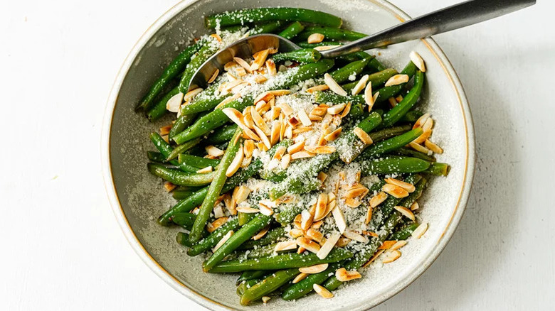 Overhead view of a dish of green beans almondine