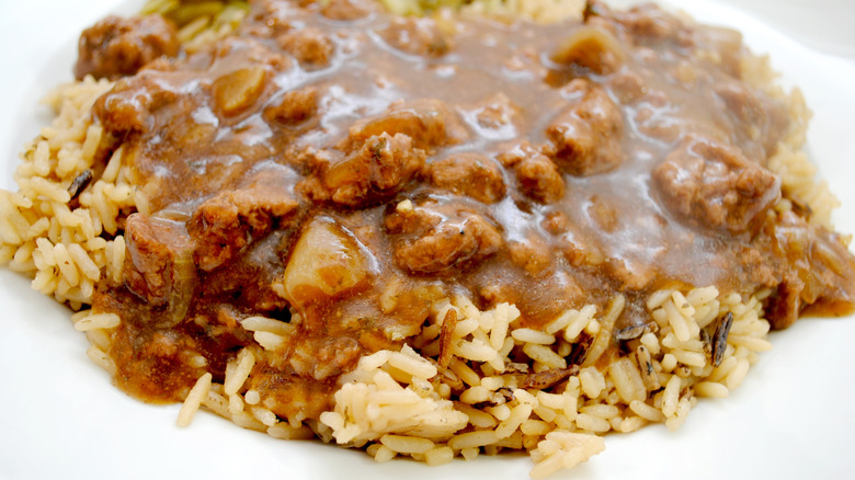 An illustrative image showing hamburger gravy over rice.