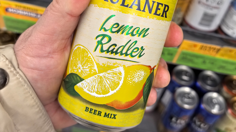 Hand holding can of radler