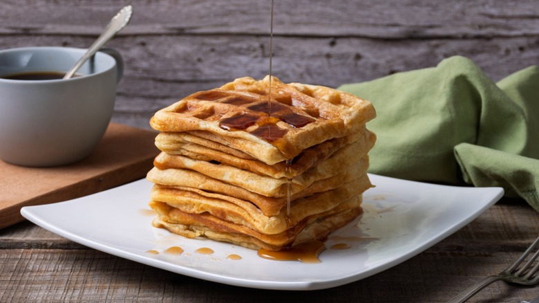 A stack of waffles with syrup