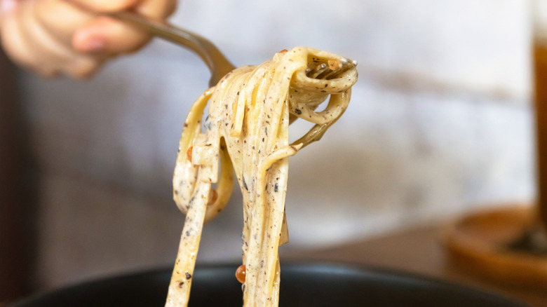 Close-up forkful of creamy truffle pasta