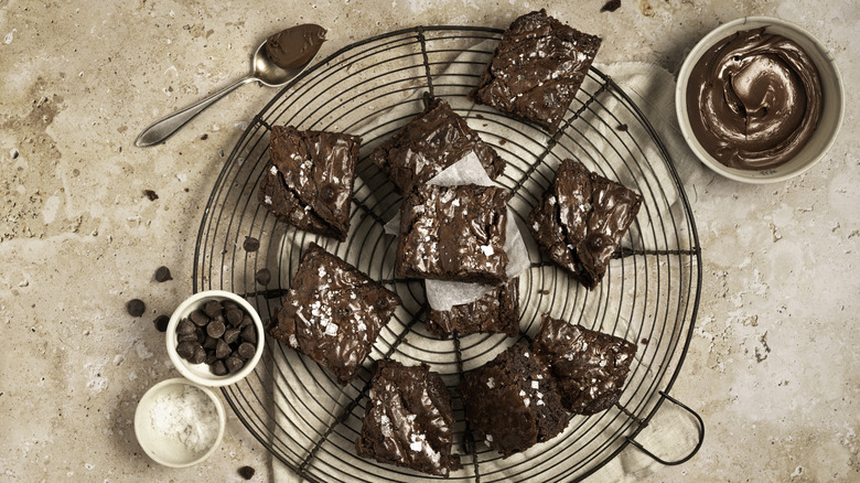 brownies on a drying rack surrounded by baking ingredients