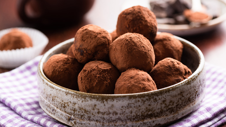 chocolate truffles in a ceramic dish on a table
